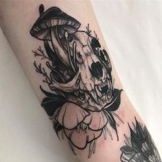 a black and white photo of a skull with flowers on it's left leg