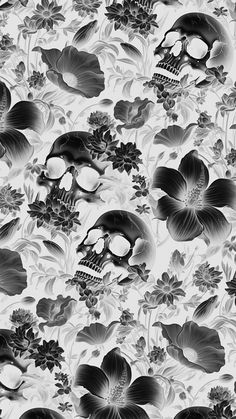 a black and white photo of skulls, flowers and leaves on a wallpaper background