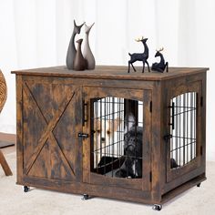 a dog in a cage with some figurines sitting on top of the cage