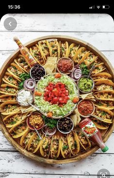 a platter filled with tacos and condiments