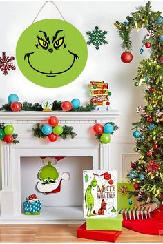 the grin face is hanging on the wall next to a christmas tree and other decorations