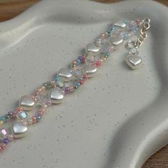 Y2K inspired candy heart beaded braided  bracelet. Made with sterling silver, tarnish resistant materials :) Heart Bead Bracelet, Heart Braid, Candy Hearts, Bracelets Diy, Braided Bracelet, Heart Candy, Heart Beads, Braided Bracelets, Bead Bracelet