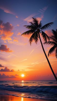 the sun is setting over the ocean with two palm trees in front of an orange and blue sky