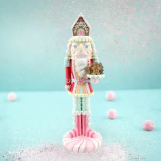 a nutcracker figurine is holding a tray of candy and confetti