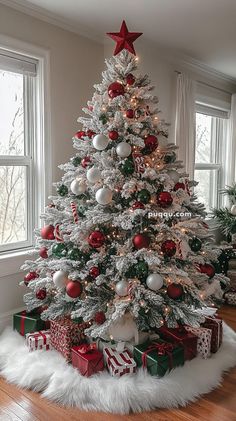 a white christmas tree with red and green ornaments