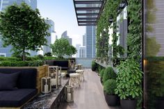 an outdoor seating area with potted plants on the roof