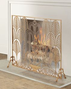 an ornate fireplace screen with gold paint on the front and sides, in a living room