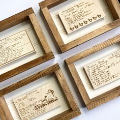 four wooden frames with writing on them