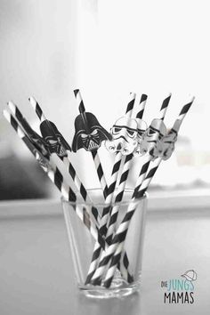 darth vader straws in a clear glass with black and white striped paper straws