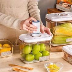 two containers with food in them and one container filled with corn on the cob