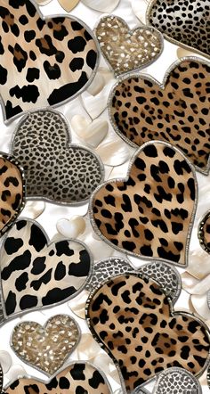 several heart shaped animal print patches sitting on top of each other in the shape of hearts