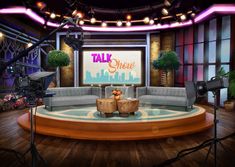 a tv studio with two couches and a table