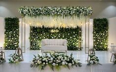 an elegant wedding setup with white flowers and greenery