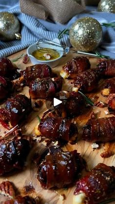 a wooden cutting board topped with meat covered in sauce