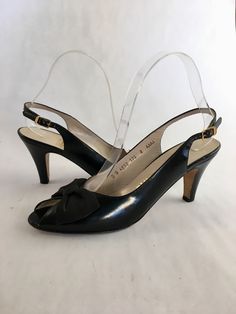 "Classic looking peep toe slingback heels by Salvatore Ferragamo! Done up in black leather with a black bow perched on the cut out, they will be sure to complement a vintage or modern look! Sold through Saks Fifth Avenue. Marked US 8 AAAA Heel: 3.25\" Length: 9.5\"  Ball: 2.75\"" Black Bow Slingback Pumps For Evening, Evening Black Slingback Pumps With Bow, Black Slingback Pumps With Bow Straps For Party, Leather Evening Slingback Pumps With Open Toe, Classic Formal Slingback Pumps With Open Toe, Formal Heels With Bow Straps And Round Toe, Black Open Toe Heels With Bow, Evening Closed Toe Heels With Bow Straps, Evening Heels With Bow Straps And Closed Toe