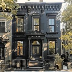 an old black house with many windows and doors