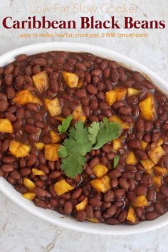 a white bowl filled with black beans and topped with cilantro