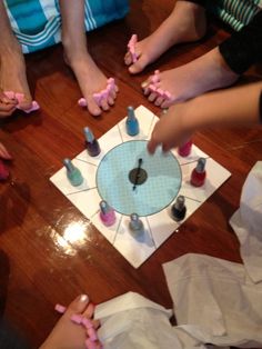 several people sitting around a table with manicures on their hands