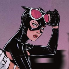 an image of a woman in catwoman costume with her hands on her head and looking at the camera