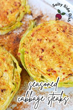 three baked cabbage stacks on a baking sheet with the words seasoned cabbage stars above them