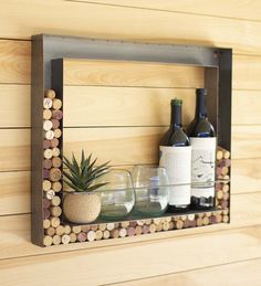 a wooden shelf with wine bottles and glasses on it