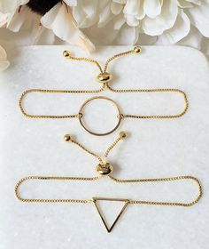 Gorgeous minimalist geometric adjustable bracelets! Choose your shape (circle or triangle).14k gold plated bracelet and 18k gold plated shapes. Adjustable slide opening up to 9 inches. Triangle Bracelet, Slide Bracelet, Shape Circle, Hippie Bracelets, Gold Plated Bracelets, Gold Geometric, Adjustable Bracelet, Arm Band, Jewelry Bracelets