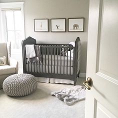 a baby's room with a gray crib and white carpeted flooring