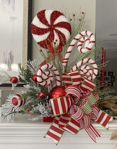 a decorated mantle with candy canes and christmas decorations