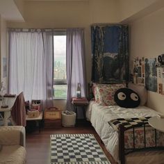 a bedroom with a checkered floor and lots of pictures hanging on the window sill