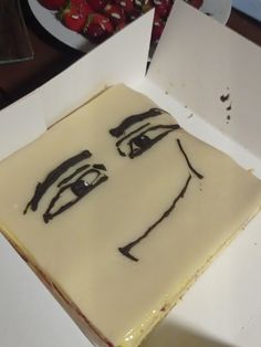 a piece of cake with a face drawn on it