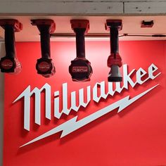 the milwaukee logo is on display in front of several other watch parts hanging from hooks