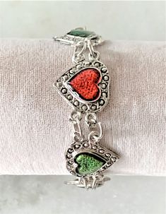 "Antique Silver Tone Resin Hearts Link Bracelet with Silver Ball Fob and Spring Ring Closure 7 Hearts Etched with Circles and Hand Painted with Resin Measures 8\" Long x 3/4\" Wide Lilac, Turq, Green, Red Hearts Silver Tone Ball Fob & Spring Ring Clasp Imported COMPLIMENTARY DOMESTIC SHIPPING" Vintage Multicolor Jewelry For Valentine's Day, Valentine's Day Multicolor Nickel-free Jewelry, Multicolor Metal Jewelry For Valentine's Day, Valentine's Day Multicolor Metal Jewelry, Adjustable Green Jewelry For Valentine's Day, Vintage Adjustable Heart Bracelet For Valentine's Day, Resin Hearts, Metal Heart, Faux Pearl Necklace