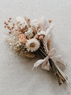 a bunch of dried flowers sitting on top of a table