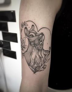 a woman's arm with a heart shaped tattoo on it and an elephant in the middle