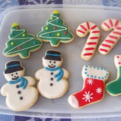 decorated christmas cookies on a plate with candy canes