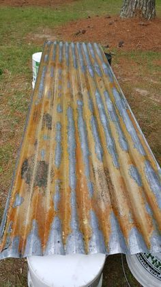 an old metal roof with rusted paint on it