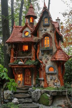 a house made out of rocks and wood in the woods with lights coming from windows