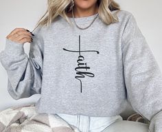 This faith-based Christian sweatshirt is a cozy and stylish way to express your beliefs. Featuring an inspiring message that reminds you of God's love and guidance, it's perfect for staying warm while sharing your faith with the world. Ideal for everyday wear or church gatherings, this sweatshirt offers both comfort and a powerful reminder of hope and grace. Wear it as a testimony of your faith and a source of encouragement for others. This Sweatshirt is ideal for casual outings or cozy days at Christian Sweatshirt, Faith Shirt, Cozy Sweatshirts, Christian Clothing, Christian Gifts, Stay Warm, Style Vintage, Vintage Stil, Everyday Wear