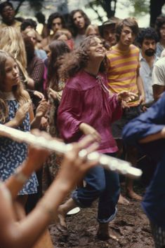 a group of people standing next to each other in front of a crowd with one person holding a frisbee