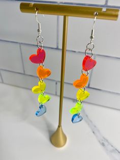 Our Fluorescent Rainbow Heart earrings are the perfect statement earring to show your pride, support or just your fun personality! Each pair is laser cut and engraved and use a sterling silver earring hook and a silicone back. We recommend taking earrings off before showering, swimming or sleeping. Love statement earrings? Check out our other styles. Want a different color combination, glitter or mirror options? Message me to place an order for a custom pair. *Colors may vary from screen to scre Pride Earrings, Fun Personality, Pride Support, Earring Hook, Heart Dangle Earrings, Statement Earring, Rainbow Heart, Silver Earring, Stocking Stuffer