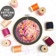 an embroidery project with spools of thread and spools of thread on the table