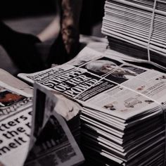 a pile of newspapers sitting on top of a table