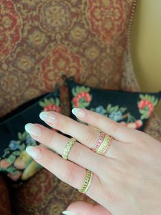 a woman's hand with two rings on it