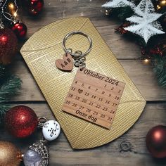 a wooden calendar keychain sitting on top of a table next to christmas ornaments