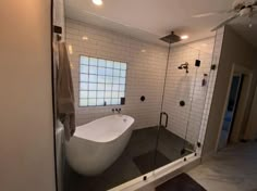 a bathroom with a large bathtub and tiled walls