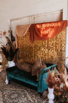 a couch sitting on top of a rug in front of a wall with gold sequins