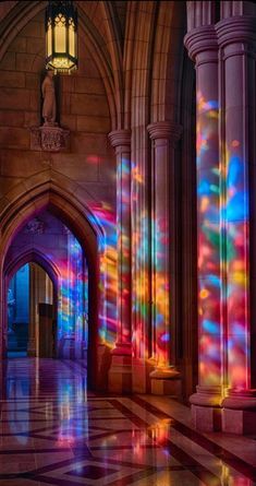 the light is shining brightly through the windows in this building's entryway, with columns and arches on either side