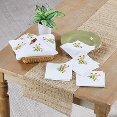 a table with napkins and a potted plant on it