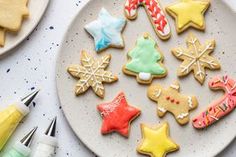 decorated cookies and crayons on a white plate