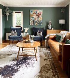 a living room filled with furniture and green walls